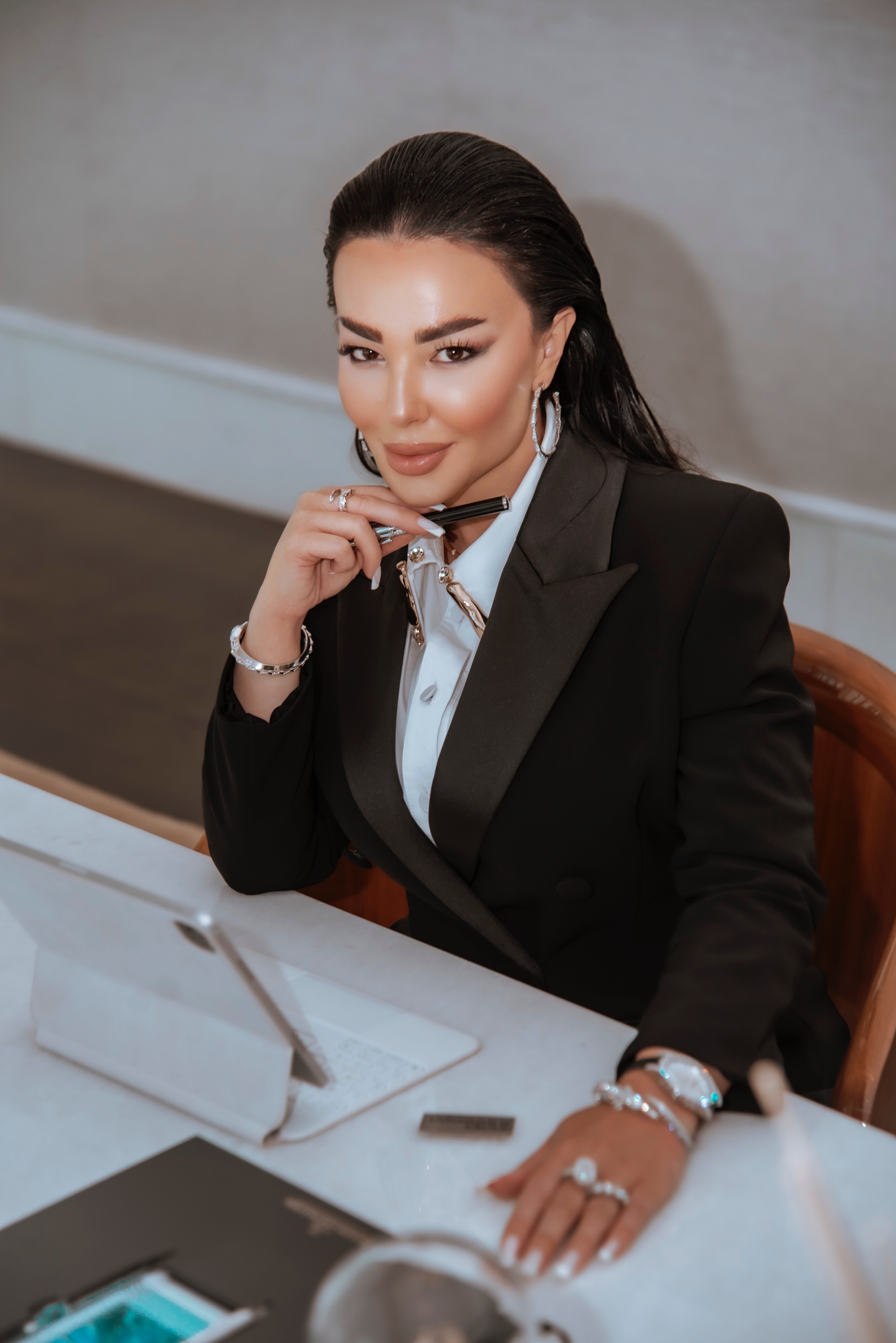 Katrina Antonovich, founder and CEO of Antonovich Group, seated at her desk