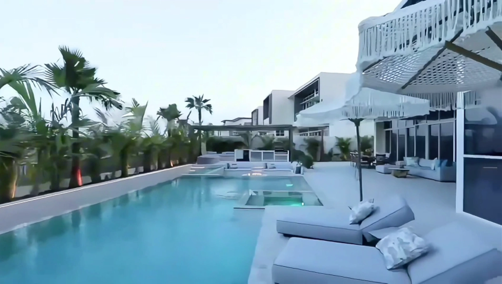 Pool, sun loungers and pergola in a completed Dubai Hills garden by Antonovich Group