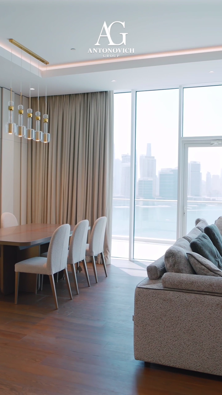 Bright apartment interior by Antonovich Group: dining and living area with floor-to-ceiling windows over the city skyline, bedrooms, a children's bunk room, a marble bathroom and a balcony above the sea