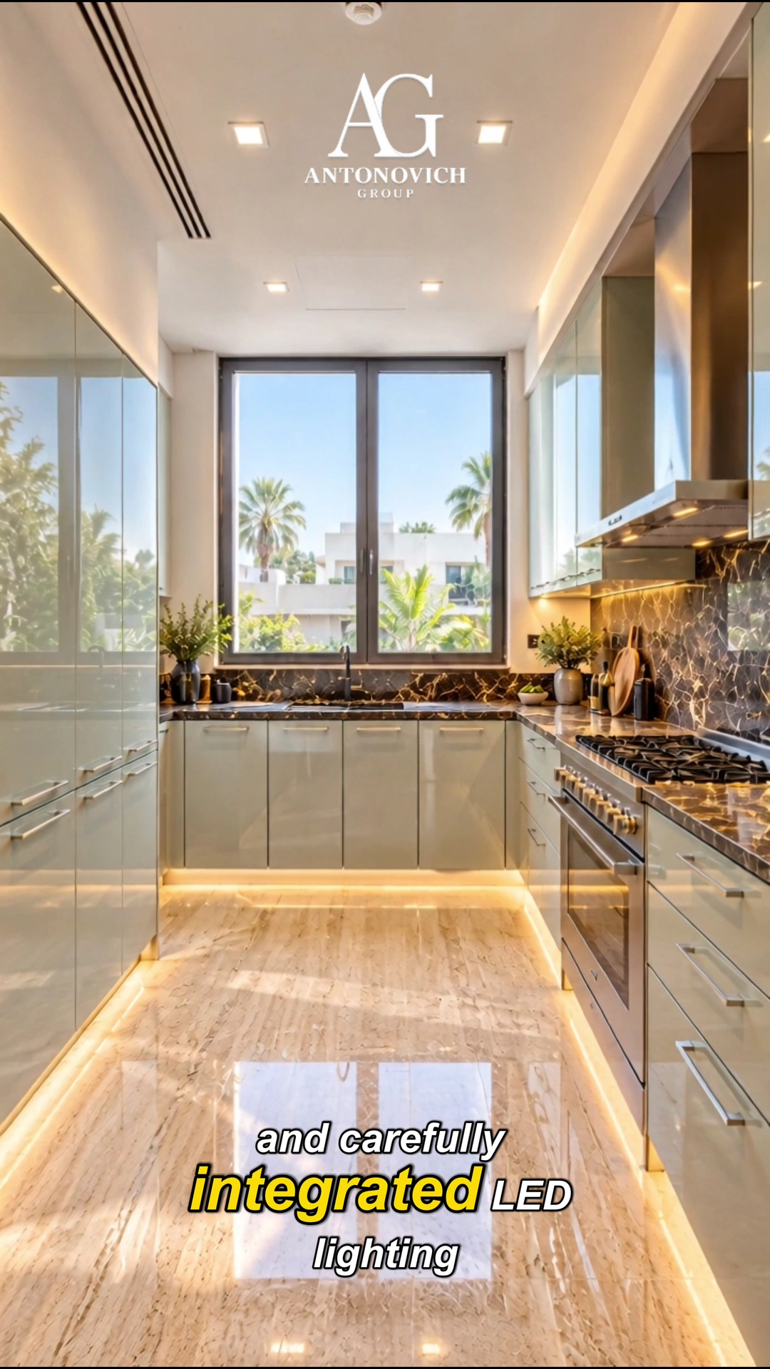 Dark lacquered kitchen with a marble island, gold pendant lighting and a patterned floor inlay