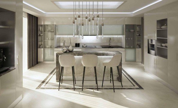 The picture shows a beach with a calm ocean, sandy shore and green palm trees. In the center of the picture, two people are standing together, smiling and looking out at the view. There is a bright blue sky overhead with a few puffy white clouds.