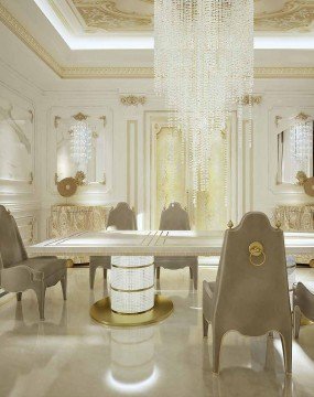 The picture shows a close up of the face of an orange tabby cat. Its eyes are squinted and its head is slightly tilted to the side. Its fur is light orange with darker stripes and spots. The cat's whiskers are visible and it appears to be looking directly at the viewer.