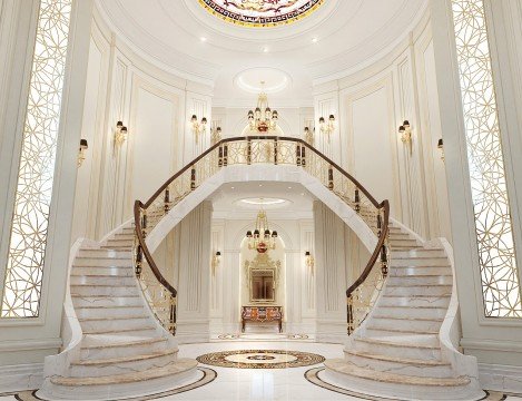 The picture shows a white house with a large, wrap-around porch and several balconies. The house has red trim around the windows and doors, and features a balcony off the second floor. There is a large, expansive lawn in the foreground of the house.