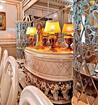 This picture appears to be a close up of a black and white cow in a field. The cow looks to be eating grass, with its head down and eyes closed.