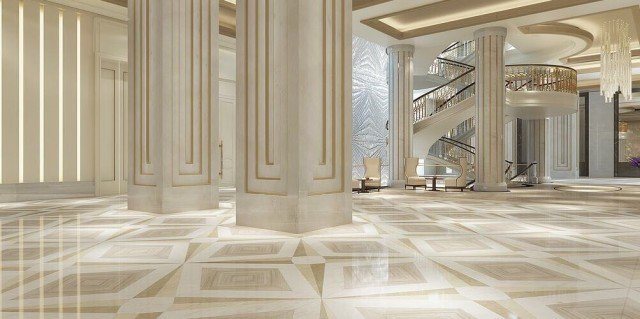 This is a picture of a woman wearing a bright pink and purple tank top with a pair of blue jeans. She has her hands on her hips and she is looking off to the side with a confident smile.