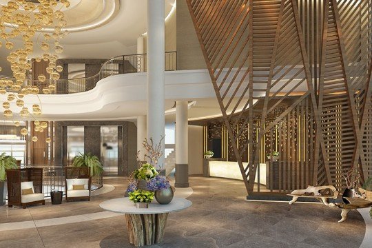 The picture shows a man standing in a field of green grass and wildflowers. He is wearing a blue plaid shirt and khaki shorts, and is looking away from the camera. There is a blue sky behind him, with white clouds and a tree in the background. The scene is peaceful and serene.