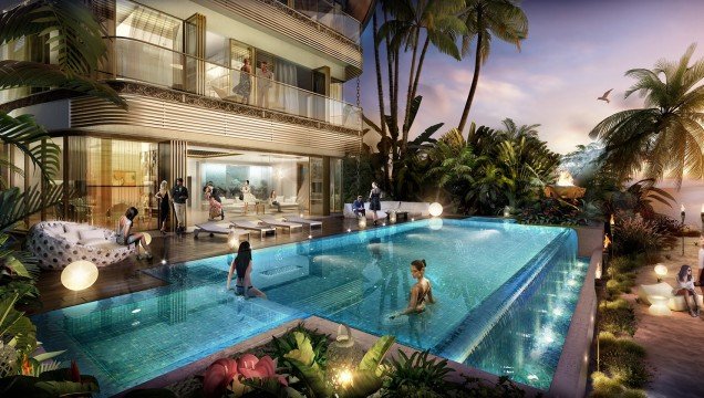 This picture shows a home at sunset surrounded by trees and a large body of water. There is a white house with a red roof, a front porch, and a dock leading out to the water. The sky is painted in hues of pink and orange, and the trees are silhouetted against the horizon.