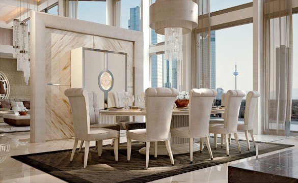 This picture shows a young Asian girl sitting on the ground in a field of tall grass. She is wearing a teal-colored dress and has her hands clasped in her lap. Her face is looking to the side, away from the camera, creating an almost dreamlike atmosphere.