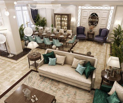 The picture is of a large tree in a lush, green forest. The tree has multiple, curved branches that reach out and up. There is a small stream in the foreground, with a bridge crossing over it. The sunny sky can be seen between the branches of the trees.