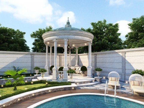 This picture shows an aerial view of a city skyline with several buildings, including skyscrapers, surrounded by water. The buildings are all lit up and there are boats visible in the water below.