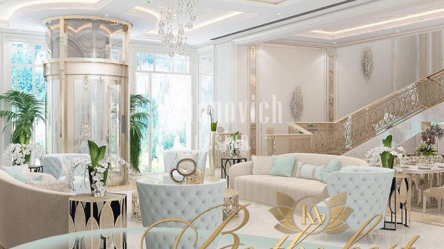 A beautifully decorated room featuring a print wallpaper, furniture upholstered in velvet and an elaborate chandelier.