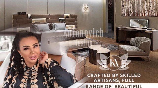 A large modern kitchen with glossy white cabinets, marble countertop, and black appliances.