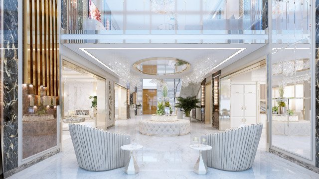 This picture is of a contemporary living room designed by Antonovich Design. The room features a large gray sofa with a matching coffee table and two arm chairs with grey and white cushions. There is a light gray rug covering part of the floor and a large wall-mounted television on the wall. The walls are painted a light beige and there are several framed art pieces hung throughout the space.