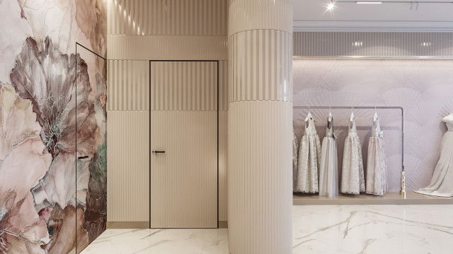 This picture shows a luxurious, modern interior of a living room. It features a curved grey sofa with plush white pillows, two grey armchairs, a polished glass coffee table, a bold black and white abstract painting hung on the wall, and a white shag area rug.