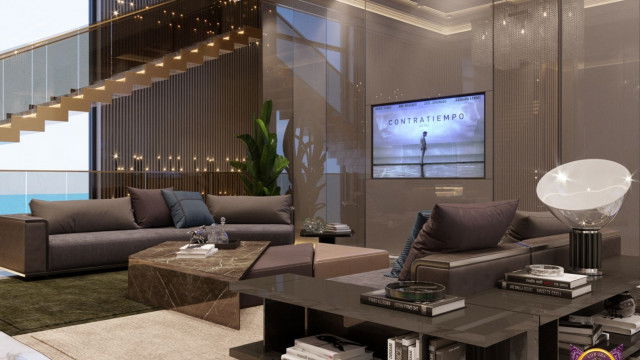 This picture shows a luxurious modern living room. The room features a grey-blue textured wallpaper with white trim. The furniture is a combination of sleek metal and comfortable beige pieces. The focal point of the room is the large crystal chandelier hanging from the ceiling. There is also a floor to ceiling window which allows natural light to filter in, giving the room an airy feel.