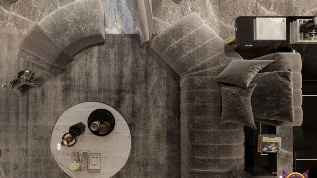 A contemporary interior featuring a white sofa, armchair, and coffee table in an open plan space with glass walls.