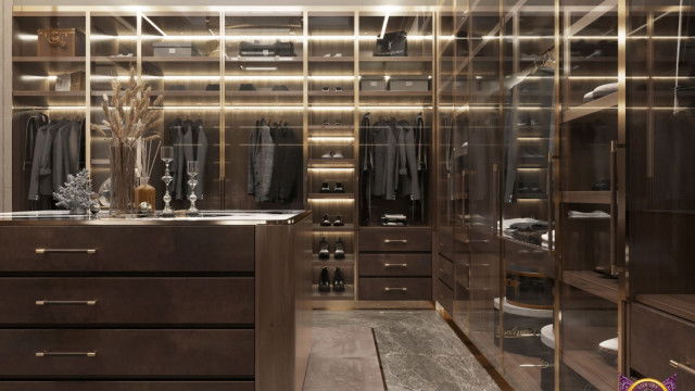 This image shows a luxurious living room with a grand piano and several sophisticated seating pieces. The walls are painted a deep navy blue and are adorned with art pieces and tall, ornate mirrors. There is also a large window, looking out to a garden beyond. The floor is a light-colored, polished wood and several elegant end tables complete the look.