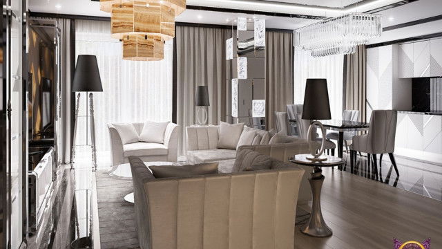 A luxuriously designed entryway featuring marble flooring, decorative columns and a ceiling with intricate moldings.