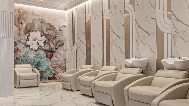 The picture shows a modern living room with a stylish white sofa, a black chair, an area rug, and contemporary art on the walls. There is also a glass coffee table and modern lighting fixtures.