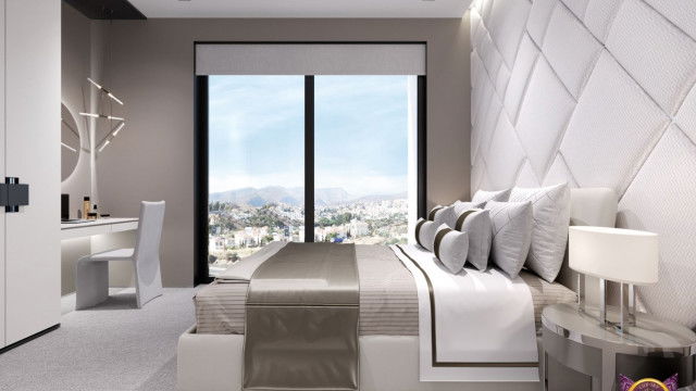 A contemporary interior with a marble floor, furniture in a pale palette and indirect lighting.