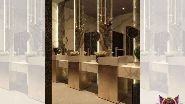 This picture shows a luxurious living room interior designed by Antonovich Design. The room features an ornate light gray sofa paired with two armchairs and a coffee table. Additionally, there is an imposing marble fireplace, ornate rug and a large flat-screen TV. An eye-catching chandelier hangs from the ceiling, and the elements are framed by intricate wall designs and white crown molding.