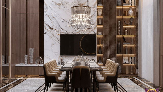 This picture shows a modern interior design project consisting of an open living area with a white leather sectional and an accompanying grey armchair. The dark wooden coffee table forms the centerpiece of the room, while modern lighting fixtures hang from the ceiling. Additionally, abstract framed artwork is hung on the wall, providing an eye-catching focal point.