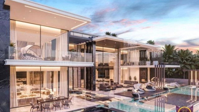 This picture shows an opulent living room with a traditional interior design. The walls are painted a deep cranberry red and feature sconce lighting, two large windows draped in beige curtains, and a large chandelier. The room also features a tufted velvet sofa and two matching armchairs, as well as two small accent tables. The floor is covered with a large oriental rug, adding further luxury to the room.