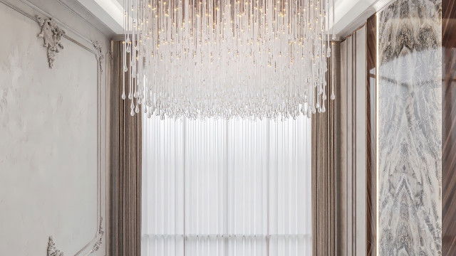 A luxury master bedroom featuring a wooden canopy bed with a chaise longue, a long dressing table, and a large mirror.