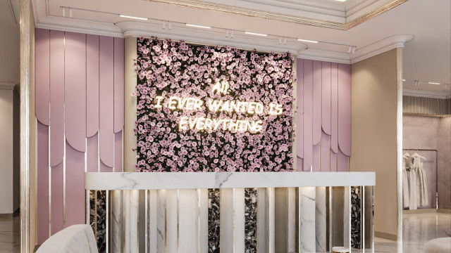 This picture shows a luxurious living room with a grand chandelier and ornate furniture pieces, creating a rich and sophisticated atmosphere. The color palette is mostly neutral shades of gray and beige, with gold accents for a regal touch. The walls feature decorative moldings and a large window looks out onto a balcony. A black grand piano stands in the corner of the room, adding to the opulence of the space.