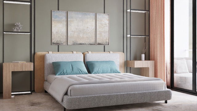 In this picture, a modern living room is shown with two white armchairs facing each other with a black and white coffee table in between them. The walls are light grey and the floor is covered with a white and grey rug. A large painting or tapestry hangs on the wall, adding a pop of color to the room. The furniture is sleek and modern and the overall look is calming and inviting.