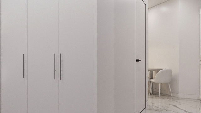 Luxurious open space featuring modern interior design with a grand double staircase, white accents, and ornate chandelier.