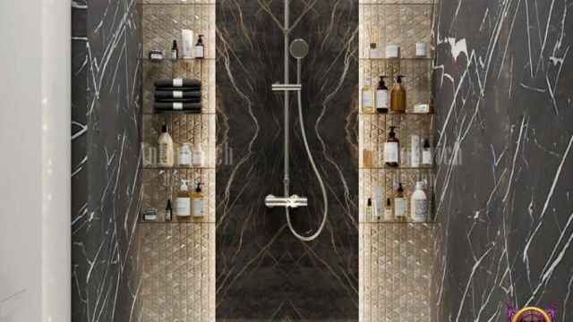 A grand staircase in a luxurious home, featuring intricate wrought iron balusters and railings on either side, a marble stair tread with ornamental mosaic inlay, and lavish chandelier.