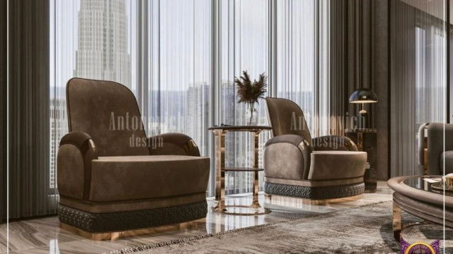 This picture shows a luxurious, contemporary living room. The walls are painted in a deep, grey color and ornate crown molding runs around the top of the walls. A stylish velvet couch, with two velvet chairs, create a cozy sitting area. A glass coffee table is visible in the center of the room, while two small tables line the walls on either side of the couch. A large fireplace is featured in one wall, and a grand piano is situated near the window that looks out onto a lush garden. The room is lit by modern pendant lamps and lots of natural light.