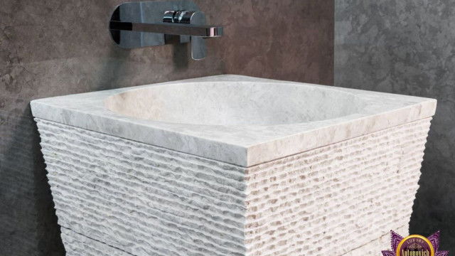 This picture shows a modern-style office with a luxurious marble floor, a large desk with a custom-made chair, and a curved sofa in the center of the room. The walls are painted a crisp white, while the ceiling has an intricate wood paneling. There is also a decorative light fixture hanging from the ceiling, giving the space a sense of sophistication and elegance.