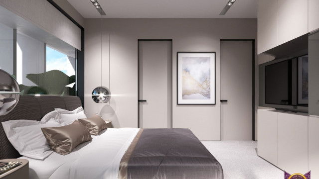 This picture shows a modern and sleek living room with an open concept design. The main feature of the room is a large and luxurious white leather sofa that features soft, curved lines. Behind the sofa, there is a comfortable armchair accompanied by a pair of ottomans. The walls are decorated with wallpaper featuring a geometric pattern that adds texture to the space. The floor is covered with a luxurious white shag rug that complements the light color scheme. There is a large window overlooking the outdoor greenery and bringing in plenty of light.