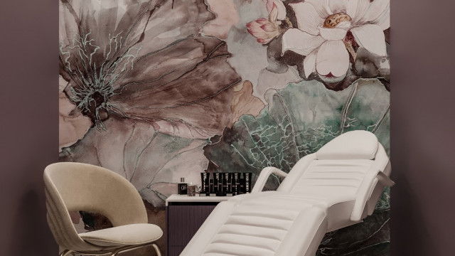 A modern kitchen with a white marble countertop, light-colored cabinets and stainless steel appliances.