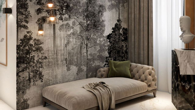 This picture shows a living room interior design, with two comfortable-looking armchairs and a sofa arranged around a round coffee table. The furniture is finished in neutral colors that provide a calming atmosphere, and the walls are decorated with art in muted shades. Crisp white details and touches of greenery provide a soft contrast to the overall look.