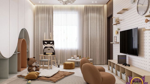 This picture shows a beautiful and luxurious modern bathroom design created by Antonovich Design. The walls feature a taupe marble mosaic with a suspended vanity illuminated by two glass wall sconces. There is a freestanding soaking tub with a gold trim and overhead rain showerhead. The flooring is a warm gray tile with a unique patterned area rug to add a touch of sophistication.