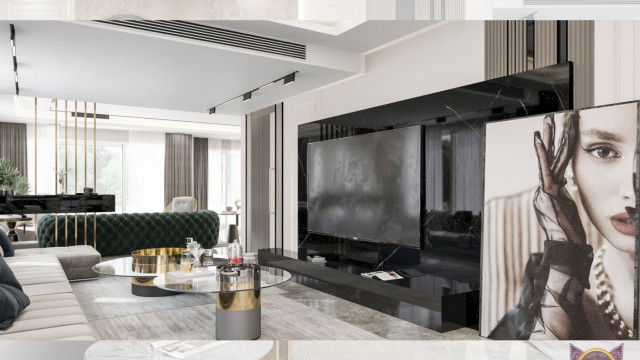 This picture shows a modern entryway with a grand staircase. The space features wooden flooring, black-framed French doors, and a white marble floor. The walls are painted a light beige color and two large abstract art pieces hang above the stairs. The stairs are lined with polished chrome banisters and steps, and feature a stylish chandelier suspended from the ceiling.