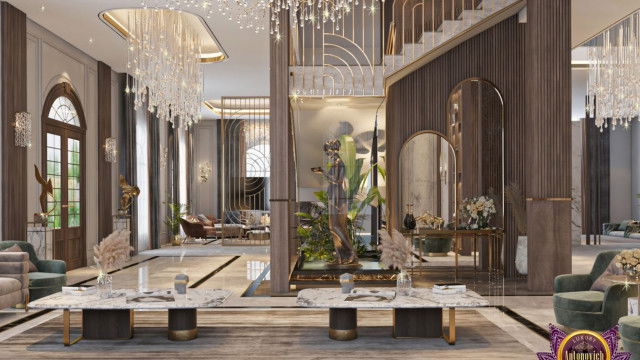 This image is of a modern luxury living room designed by Antonovich Design. It features a white and gray color palette with pops of blue. The space includes two accent chairs, a sofa, a low coffee table, and a low stone-topped end table. There are two lamps on the end tables and a black floor lamp beside the sofa. The walls feature artwork and a mirror, and the ceiling has recessed lighting.