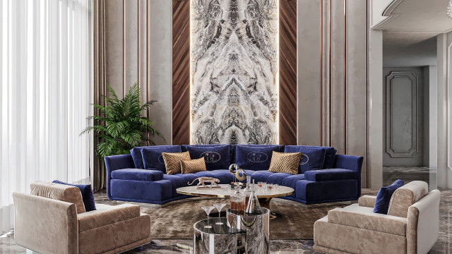 The image shown is of a modern luxury living room. The room features a grey couch, a white accent chair, and a round black coffee table. There is a large rectangular area rug with a grey and white diamond pattern and a navy blue wall. Hanging on the wall is an abstract painting with blue, white, and grey tones. The walls are also decorated with small shelves filled with books, vases, and house plants.