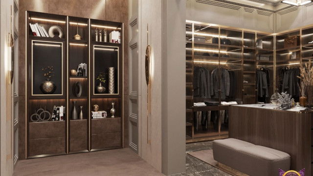 This picture shows a modern living room with a white minimalist design. There are two plush gray couches along the walls, separated by a small glass coffee table in the center of the room. The walls are painted white and there is an abstract painting on the wall. The floor is carpeted in gray and there is a modern pendant lamp hanging from the ceiling. The overall look of the space is minimalistic and calming.