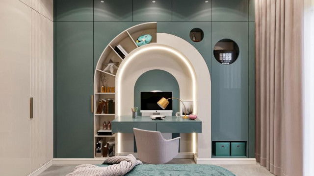 This picture shows a large, elaborate living room with a luxurious design. The walls and ceiling feature intricate moldings and decorations, while the floor has a checkerboard parquet pattern with gold-colored accents. The furniture is comprised of a lavish cream-colored sofa with tufted detailing and pillows, two ornate chairs, and a low glass coffee table. A crystal chandelier hangs from the center of the ceiling, adding a sparkle to the room.