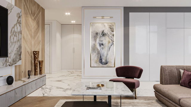 This picture shows a luxurious kitchen area with marble countertops and cabinetry. The cabinetry is crafted in a white hue and has multiple drawers and shelves that provide plenty of storage space. In addition, the kitchen has a large island which serves as a bar and provides both an additional workspace and a place to dine. There are two hanging lights that create a warm ambience in the kitchen. Finally, the walls are painted in a warm beige tone and there is tiling on the flooring, making this room look stylish and comfortable.