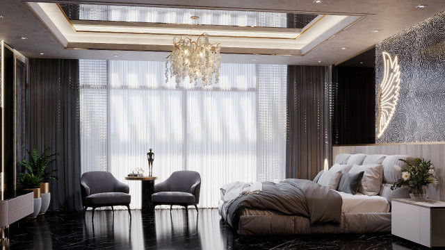 A grand, modern living room with artfully laid stone flooring, luxurious ivory furniture, and pale grey walls with accents of bright gold.