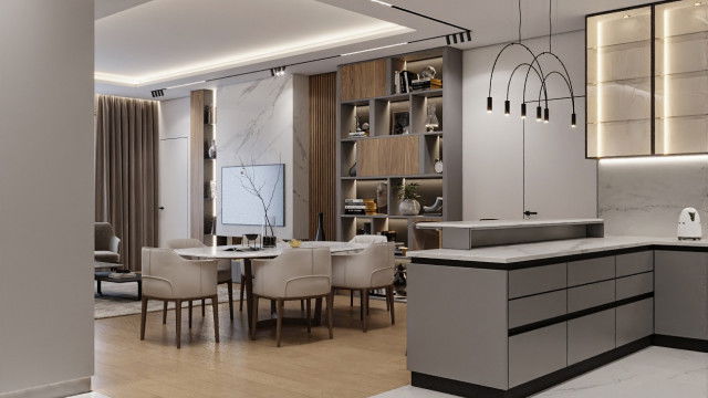 This picture shows a modern living room with a white sofa and two matching armchairs. The walls are painted in a light grey and off-white combination, and there is a large beige area rug on the floor. There is a floating TV unit to the left of the seating area, and a wall-mounted fireplace in front of the sofa. To the side of the fireplace, there is a glass accent table with a large vase and several books on it. The ceiling has recessed lighting and wooden beams, adding an industrial touch to the design.