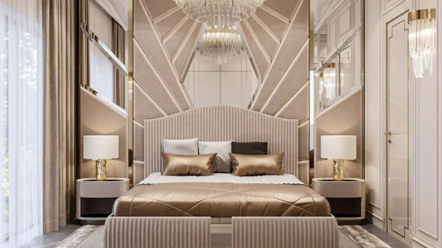 This picture shows an outdoor pool area designed by Antonovich Design. It features a large, modern pool with steps leading down into it. The blue and white tiles on the floor create a stunning contrast to the surrounding greenery and provide a cool and inviting atmosphere. There is a large deck area with comfortable loungers, as well as tropical trees and lush shrubbery. The view of the sea in the distance completes the relaxing environment.