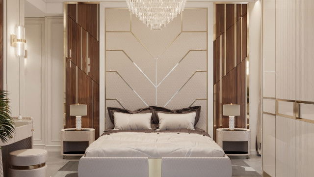 This picture shows a contemporary, minimalist living room designed by Antonovich Design. The room features a light gray sofa and armchairs with simple, muted accents, and a rug in the center of the room providing a pop of color. The walls and ceiling are painted white, while the floor is made up of dark-colored tiles. There is also a large window to the right of the room allowing natural light to flood in.