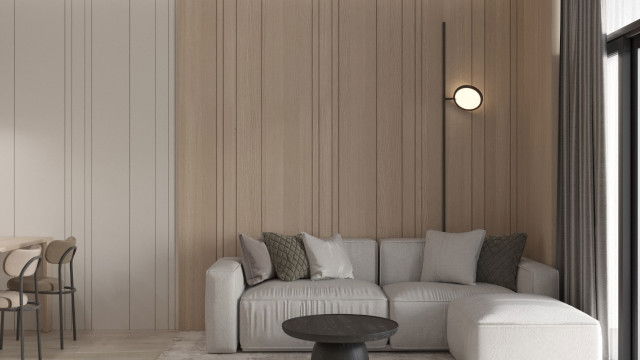 The picture shows a luxurious modern living room designed in a contemporary style. There are two white sectional couches and a glass coffee table in the center of the space. The walls are painted in a light blue color, with large windows providing natural light. On the wall above the sectional is a large abstract art piece that adds a contemporary touch to the design. There are rug and light brown wood flooring, along with some potted plants in the corner to add a hint of greenery.