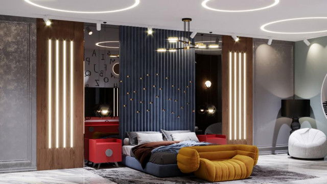 Brightly decorated bedroom with a large king-size bed, two end tables and a chaise lounge chair in the corner, adorned with colorful throw pillows.